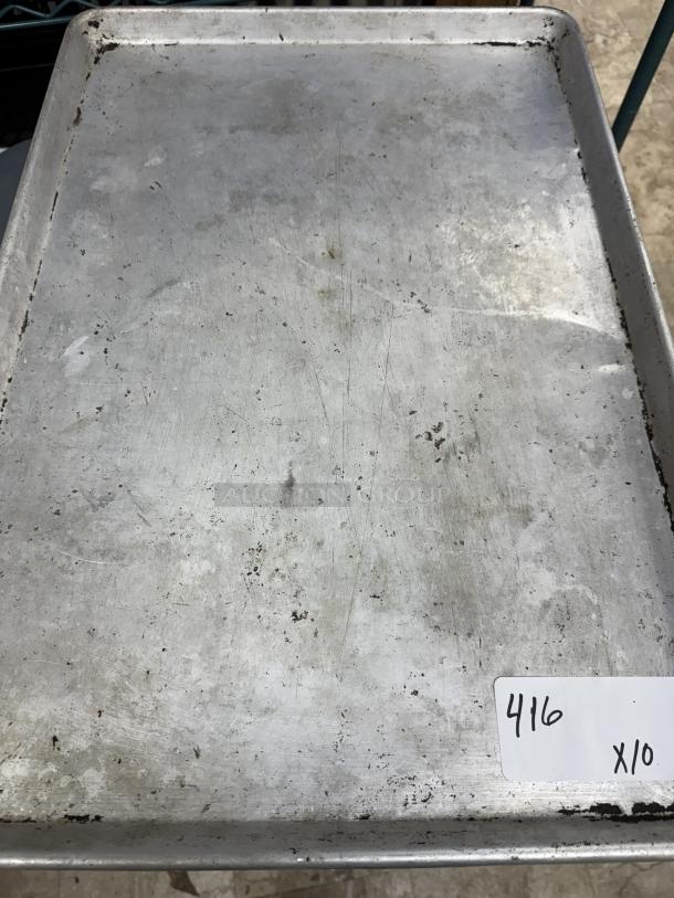 Alt text: Used full-size sheet pan with visible wear. Lot of 10, marked "416 x10" on tag. Ideal for bakery or kitchen use.