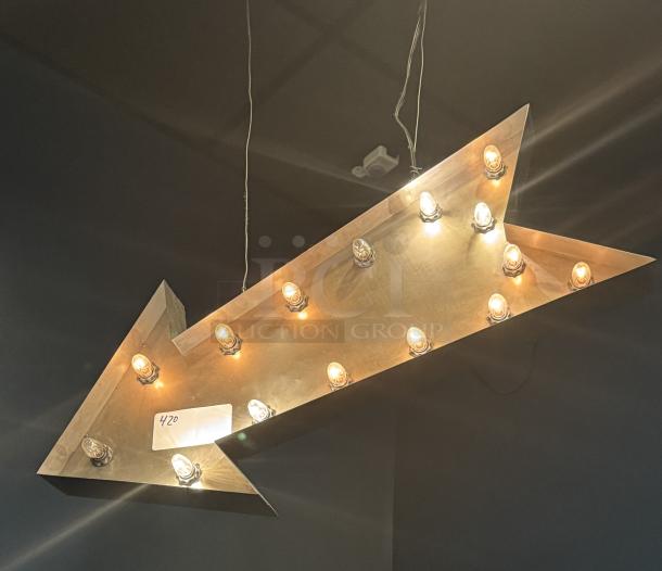 Hanging lighted arrow sign with vintage bulbs, metallic finish, illuminated outline. Price tag reads "420." Suitable for decor.