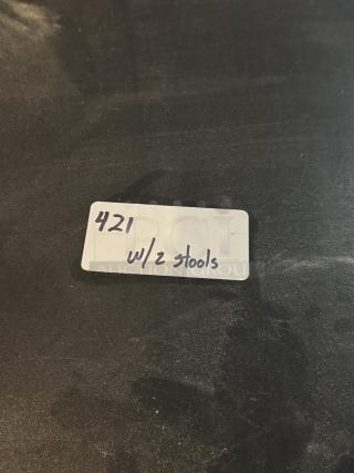 Black round bar height table with two stools, labeled "421 w/2 stools."