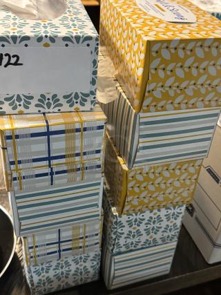 Full and opened boxes of Soft & Strong facial tissues, assorted designs, stacked. Ideal for bulk purchase.