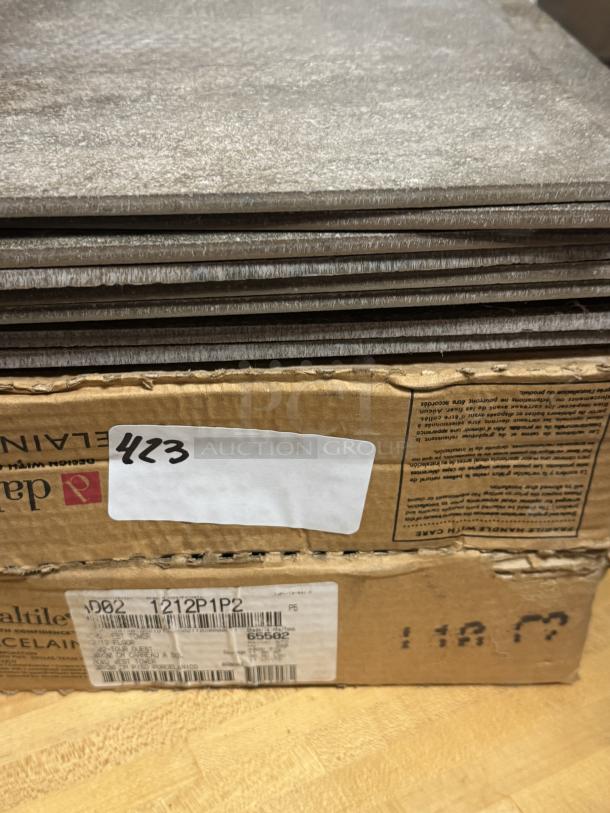Daltile porcelain floor tiles, 12" x 12", stacked and boxed. Labels show model 1212P1P2, indicating tile specifications and batch.