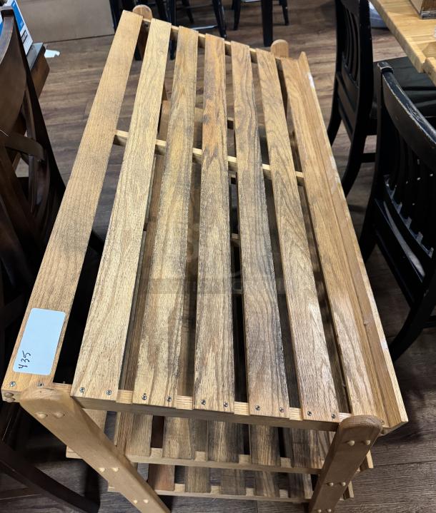 Wooden display rack with 3 shelves, light natural finish, slatted design, sturdy condition, visible label with "325."