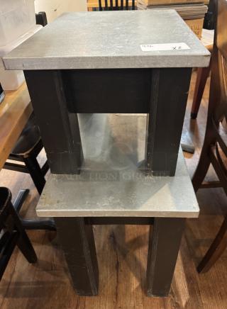 Two black tables with metal tops; larger table 30"x17"x23", smaller 23"x17"x14". Visible wear, auction tags noted.