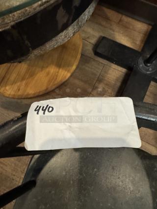 Black child's chair with a rustic finish, showing slight wear. A paper tag marked "440" is attached. Ideal for collectors.