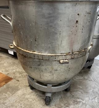 140 Qt. mixing bowl with dollie, pre-owned. Features side handles, some wear and rust spots, on rolling base for mobility.