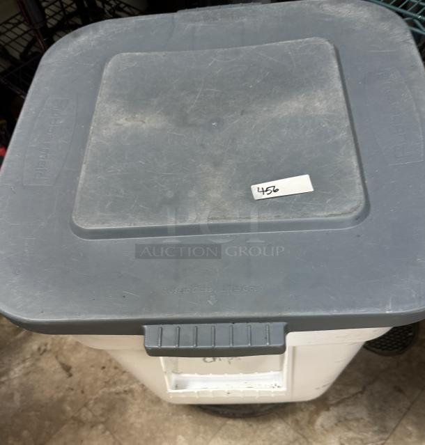 Rubbermaid 28 Gal. dry storage container with gray lid on a dollie, marked with number 456, showing slight wear.