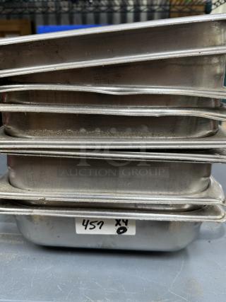 Stacked stainless steel half pans, used condition, visible production codes. Includes 9 pans, slight wear, label reads "457 x4".
