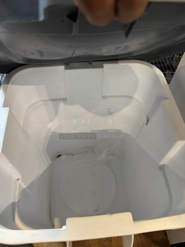 Rubbermaid 28 Gal. dry storage container, white interior, hinged lid, slight wear visible inside, suitable for bulk storage.