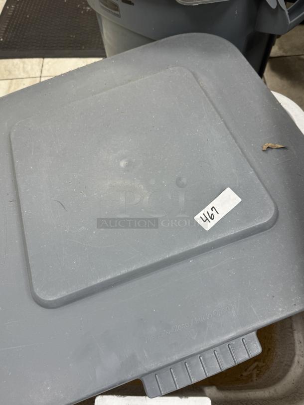 Rubbermaid 28 Gal Dry Storage Container, gray, with lid. Visible label marked "467." Shows minor wear and scuffs.