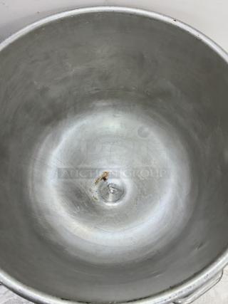 140 Qt. stainless steel mixing bowl with visible wear and rust spots on the inner surface, paired with a dollie for mobility.