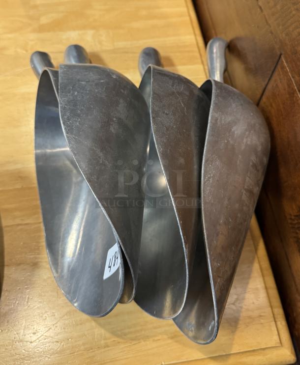 Set of four metal scoops, one 38 oz and three 58 oz, slightly worn, number label 498 visible.