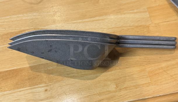 Set of three 16 oz metal scoops, stacked, showcasing sturdy design and light wear. Ideal for bulk goods handling.