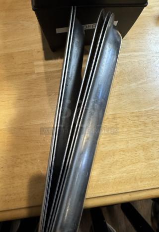 Five metal serving trays stacked, showing light wear. Suitable for serving or display. Measures approximately 14 inches long.