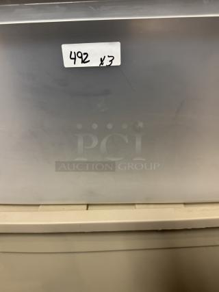 Large plastic storage totes, stackable, durable, auction lot of 3. Label reads "492 x 3." Ideal for organizing items.