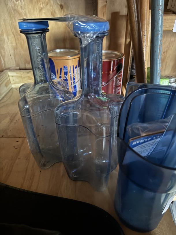 Rapi-Kool Rapid Chilling Utensil and Scoop, clear plastic, two bottles with blue caps, used for quick cooling.