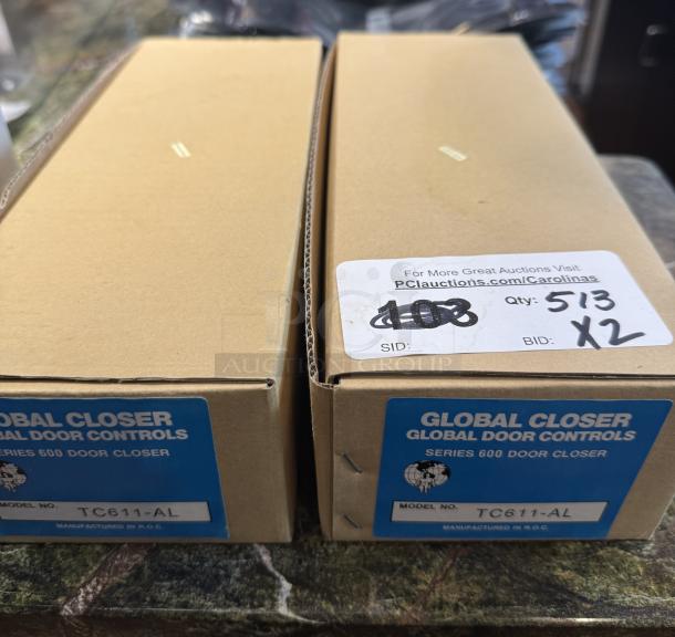 New in box Global Closer TC611-Al door closers, 2 units, labeled Series 600, auction information visible.