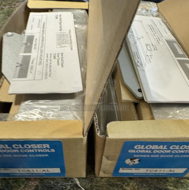 New Global Door Controls TC611-Al door closers in box. Includes instructions and mounting hardware. Set of 2.