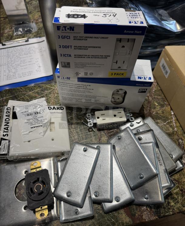 Assorted receptacle covers, new in box, includes Eaton GFCI self-test circuit interrupter, metal and plastic finishes.