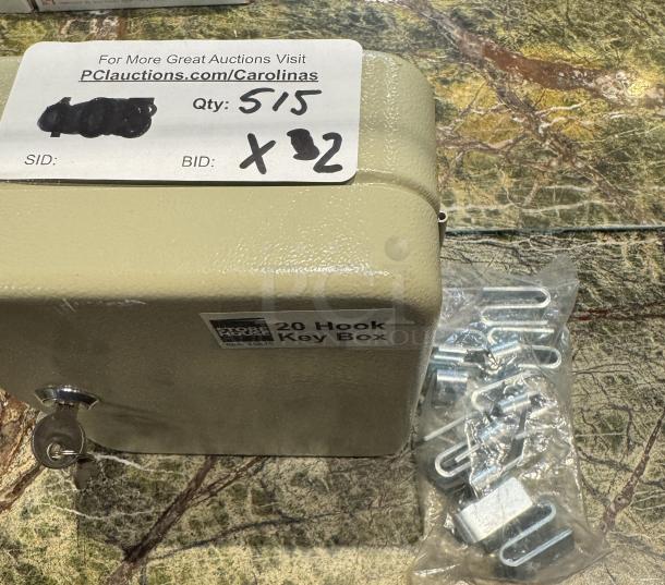 Key box with 20 hooks, beige metal, includes key and mounting hardware. Auction label with quantity 5/15, bid x2.