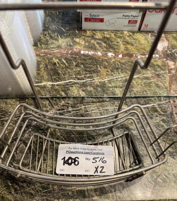 Mountable wire racks in good condition, labeled for auction with bid details. Ideal for organizing or storage use.