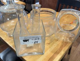Assorted glass containers, set of 4, includes various shapes; lidded and open vessels, well-maintained, auction label.