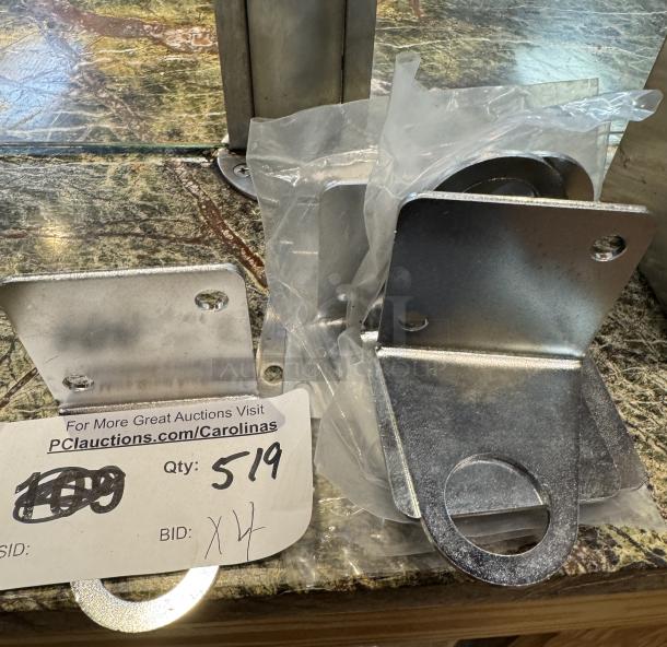 Rod holders set of four, metallic finish, new condition with mounting holes. Auction tag shows quantity 4, bid details.