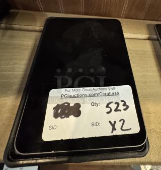 Apple iPad Mini in tested and working condition, black screen. Auction label shows quantity 523, bid x2.