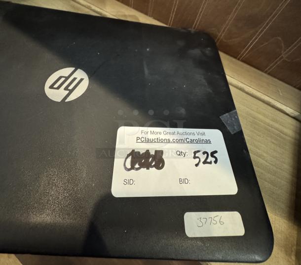 HP laptop computer with visible logo, in working condition, requires system reset. Auction label indicates quantity 525, item ID 37756.