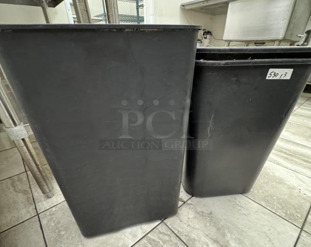 Black trash cans in used condition, two visible, with a label reading "530 x 3" indicating quantity and lot for auction.