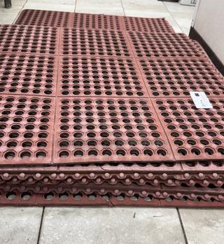 Red floor mats, perforated design, sizes 3'x3' and 5'x3', stacked. Durable material, good condition.