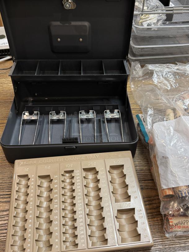 Steel Master cash box with locking lid, coin wrappers, and beige change tray with denominations. Good condition.