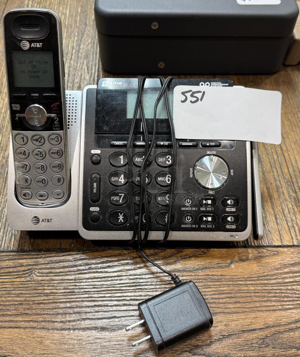 AT&T 2 Line Telephone/Answering Machine, silver and black, with handset and power adapter; label reads "551."