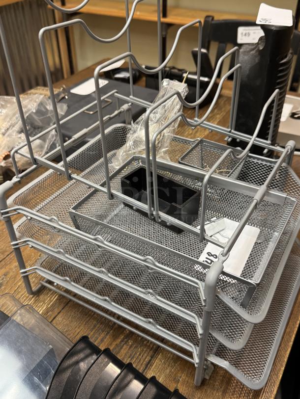 Metal desk organizer with tray and baskets, in good condition. Mesh design, ideal for storage and organization.