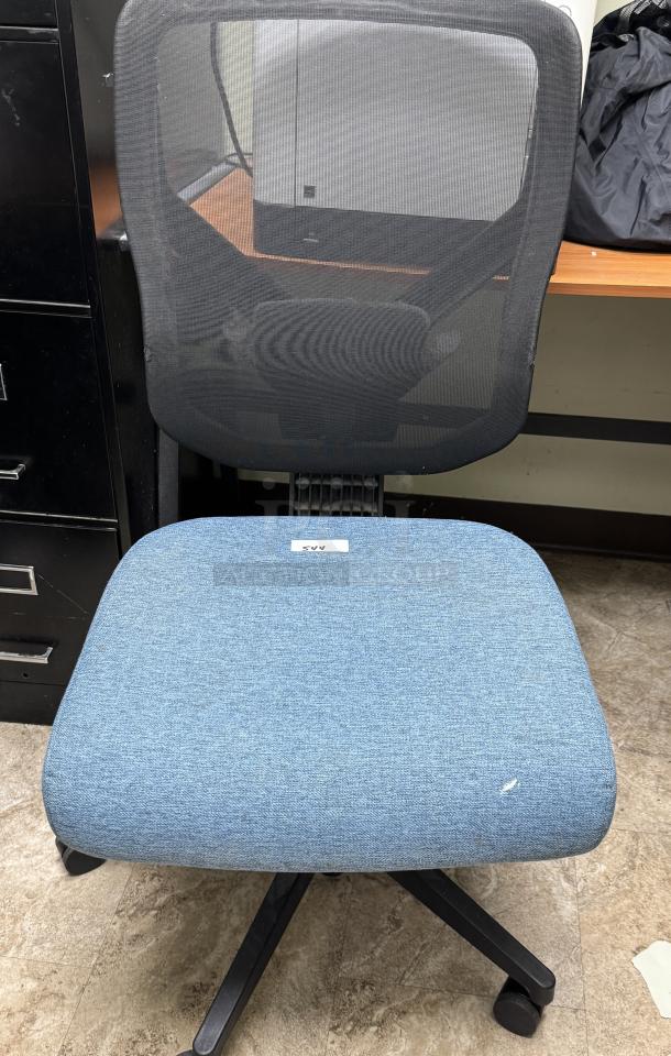 Blue swivel office chair with mesh back, cushioned seat. Features slight fabric wear. Tag labeled "544." Adjustable height.