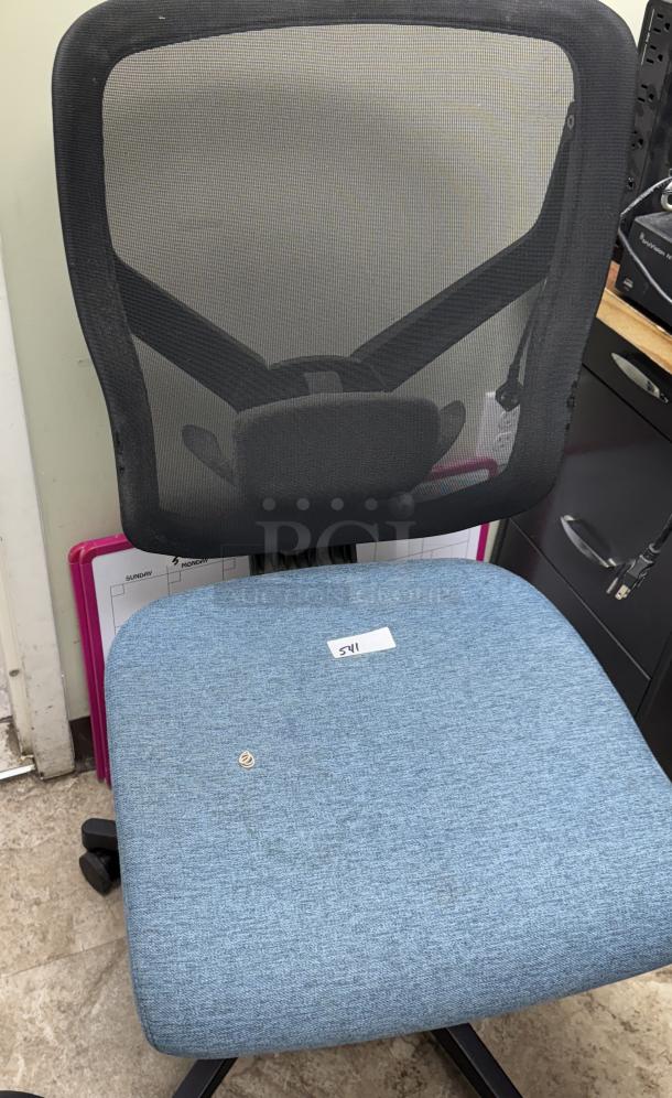 Blue swivel office chair with mesh back, padded seat. Visible tag “541”. Good condition, minor use signs.