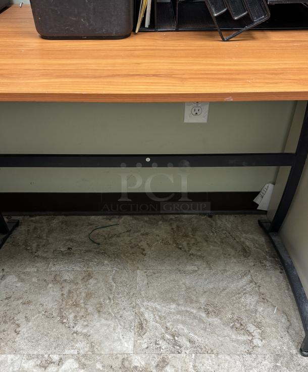 Wooden corner office desk with metal legs, gently used condition. Features storage trays and a tidy cable management system.