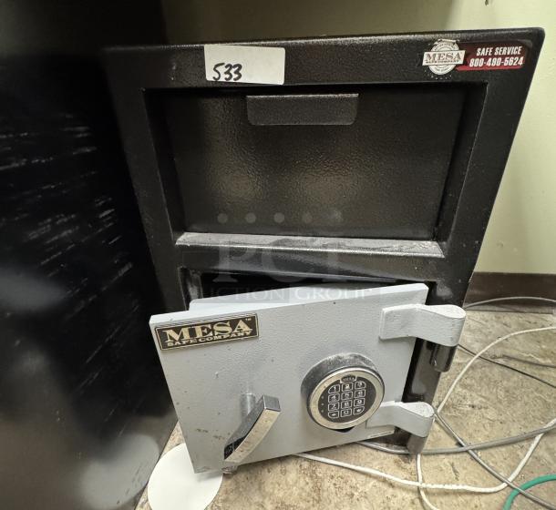 Mesa Safe with combination lock, black and gray, some wear visible. Label: "Mesa Safe Company." Tag: "533."