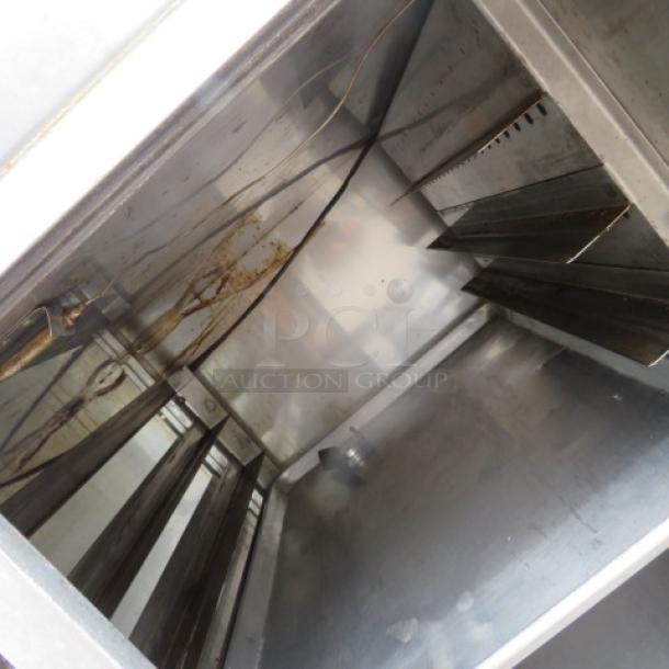 NUVU heated holding cabinet interior with stainless steel racks and wiring, showing signs of wear. Measures 48x31x64 inches.