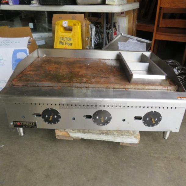 Patriot PT-G36-T natural gas griddle, 36"x28"x16", thermostat controlled. Missing 3 knobs, visible wear on the surface.