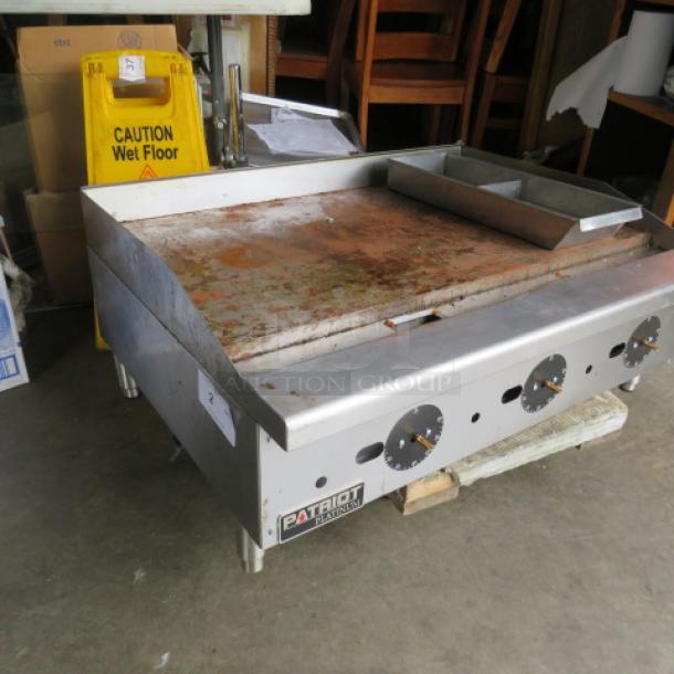 Patriot PT-G36-T natural gas griddle, 36x28x16, used condition, missing 3 knobs, visible rust on surface.