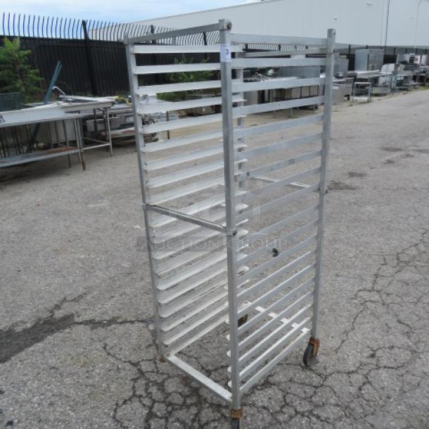 Aluminum speed rack on casters, 20.5x26x64 inches. Missing one caster. Ideal for commercial kitchens.