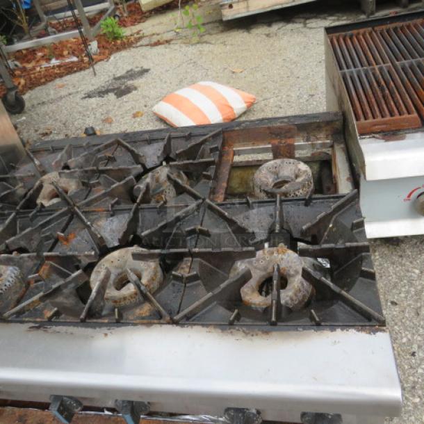 Radiance natural gas 6 burner range, missing 1 grate, 36x30x12 inches, used condition, outdoor setting.