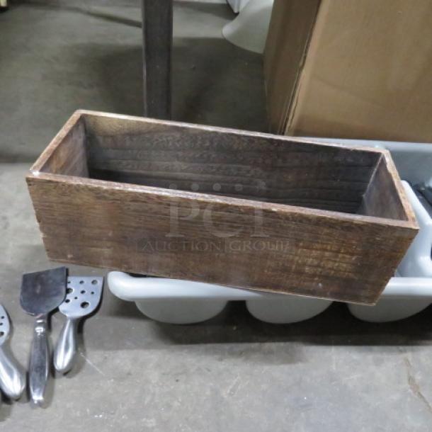 Rectangular wooden box holder, rustic finish, used condition, visible grain texture. No visible markings or labels.