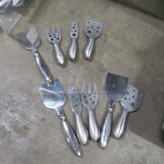 One lot of 9 stainless steel cheese serving tools, including slicers and forks, in good condition.