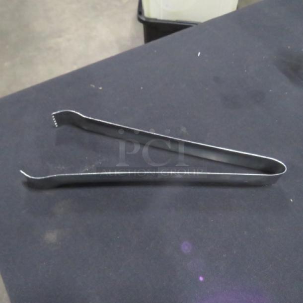 9.5-inch stainless steel tongs, model 6XBID, in good condition. Simple design, durable metal construction.