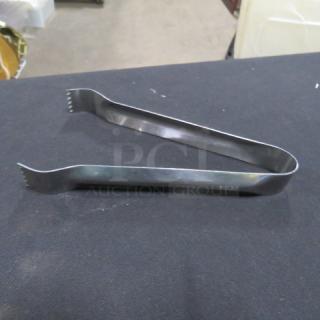 6 Inch Stainless Steel Tongs, model 6XBID, in good condition. Durable material, slight wear, ribbed ends for grip.