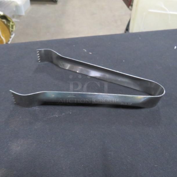 Stainless steel 6-inch tongs, model 6XBID, in excellent condition, featuring serrated edges for secure grip.
