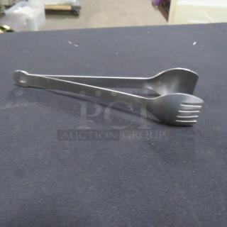 Stainless steel tong, model 6XBID, features scalloped edges, durable, in good condition. Ideal for kitchen use.