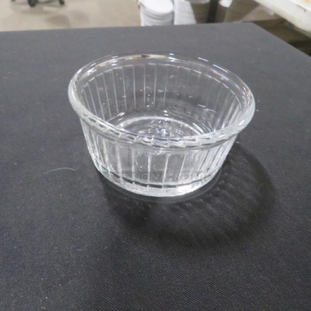 Clear glass ramekin with vertical ribbed design, excellent condition, ideal for baking or serving, model 8XBID.