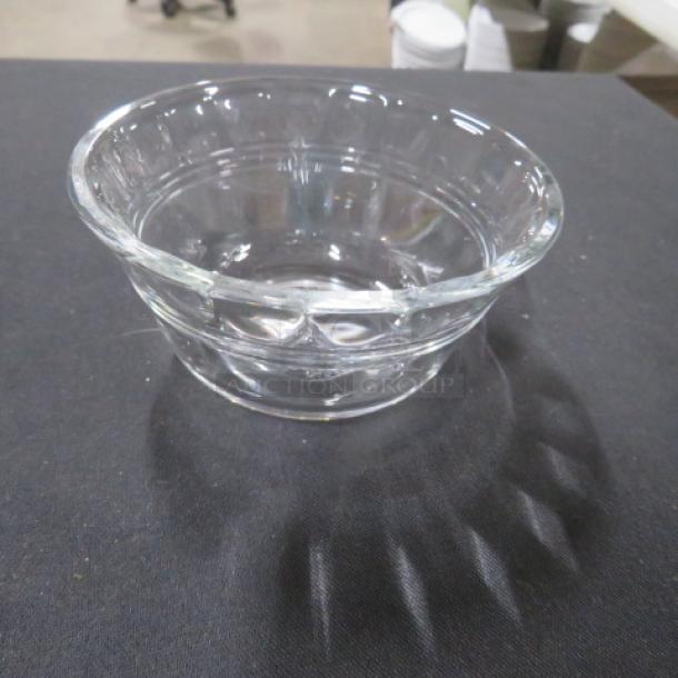 Clear glass ramekin, model 13XBID, in excellent condition. Features smooth, rounded shape ideal for baking or serving.